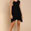 Model is wearing Wildest Rose tunic dress in black with babydoll silhouette and ruffle hem - front view