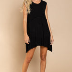 Model is wearing Wildest Rose tunic dress in black with babydoll silhouette and ruffle hem - front view