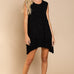 Model is wearing Wildest Rose tunic dress in black with babydoll silhouette and ruffle hem - front view