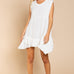 Model is wearing Wildest Rose tunic dress in off white with baby doll silhouette and ruffle hem