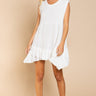 Model is wearing Wildest Rose tunic dress in off white with baby doll silhouette and ruffle hem