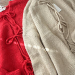 Close-up of the Willow Boho Tie Cardigan (Sadie Tie Front Cardigan) in red showing the tie-front detail and soft knit texture.