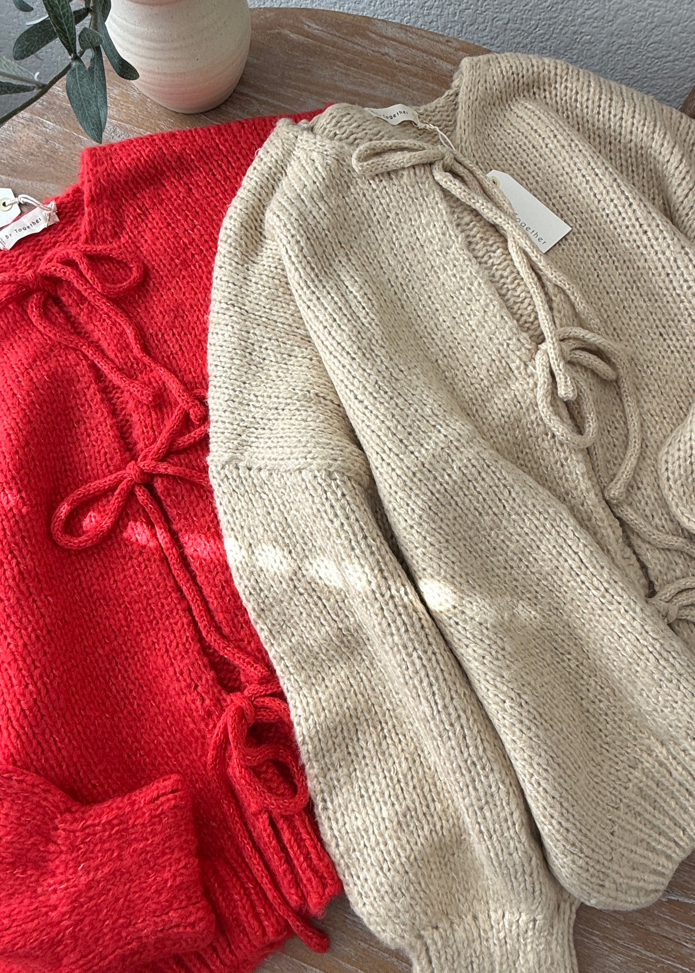 Close-up of the Willow Boho Tie Cardigan (Sadie Tie Front Cardigan) in red showing the tie-front detail and soft knit texture.