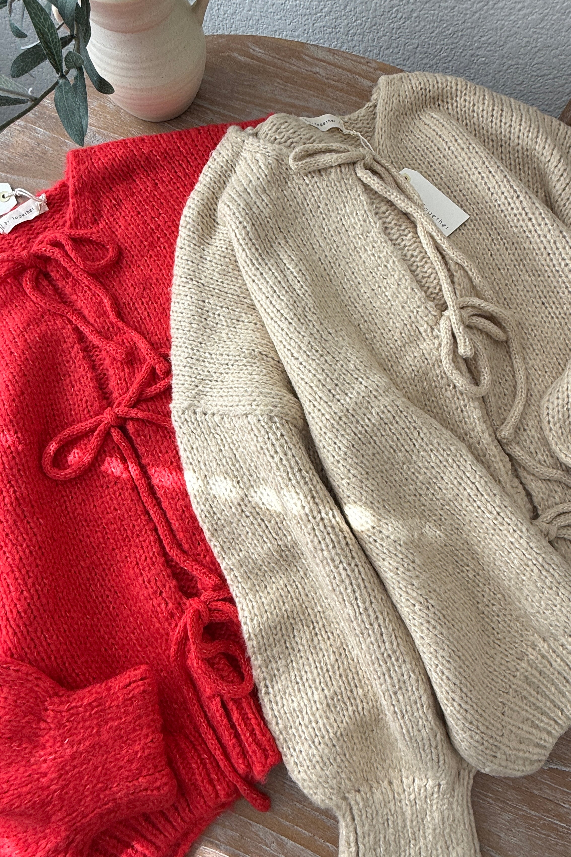 Close-up of the Willow Boho Tie Cardigan (Sadie Tie Front Cardigan) in red showing the tie-front detail and soft knit texture.