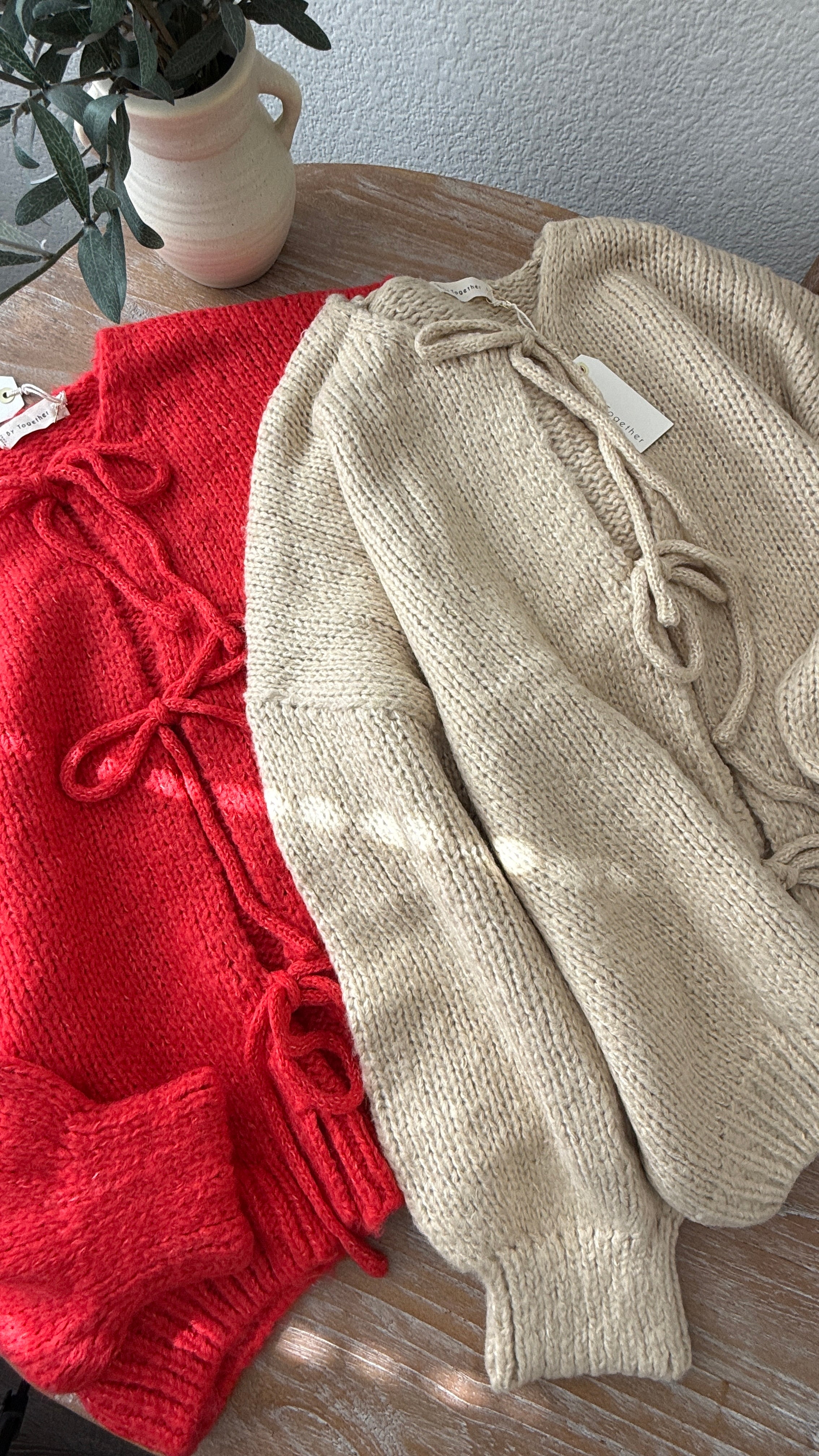 Close-up of the Willow Boho Tie Cardigan (Sadie Tie Front Cardigan) in red showing the tie-front detail and soft knit texture.