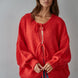 Woman wearing the Willow Boho Tie Cardigan, also known as the Sadie Tie Front Cardigan, in red — soft boho knit with tie-front closure and scoop neckline.