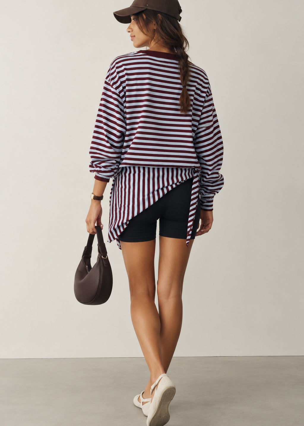 Model wearing the Remi wine and blue striped sweatshirt with a matching hip scarf and jeans - back view