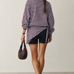 Model wearing the Remi wine and blue striped sweatshirt with a matching hip scarf and jeans - back view