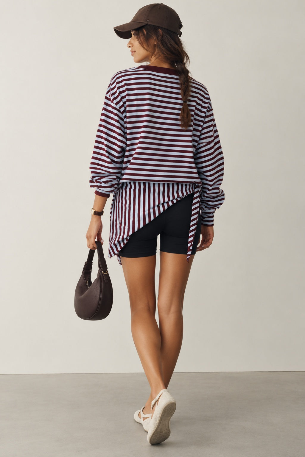 Model wearing the Remi wine and blue striped sweatshirt with a matching hip scarf and jeans - back view