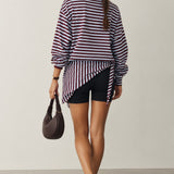 Model wearing the Remi wine and blue striped sweatshirt with a matching hip scarf and jeans - back view