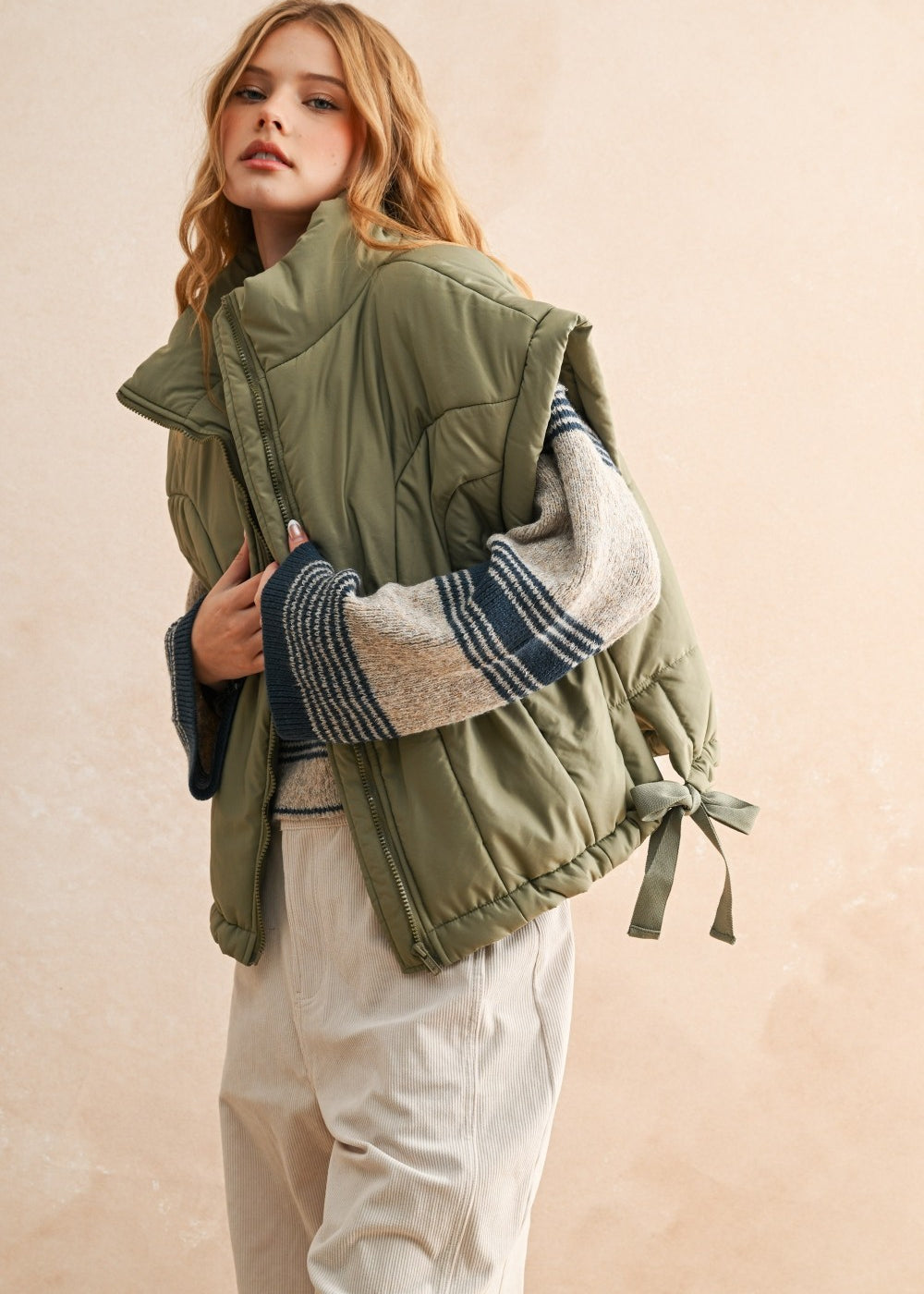 Close-up of quilted nylon fabric on olive puffer vest — durable and soft material for everyday wear.