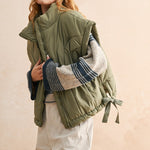 Close-up of quilted nylon fabric on olive puffer vest — durable and soft material for everyday wear.