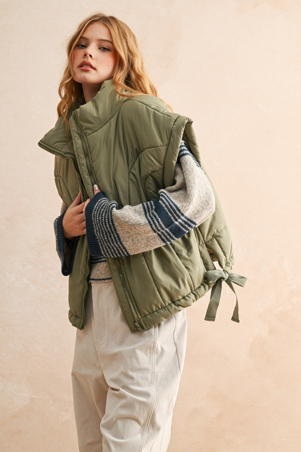 Close-up of quilted nylon fabric on olive puffer vest — durable and soft material for everyday wear.